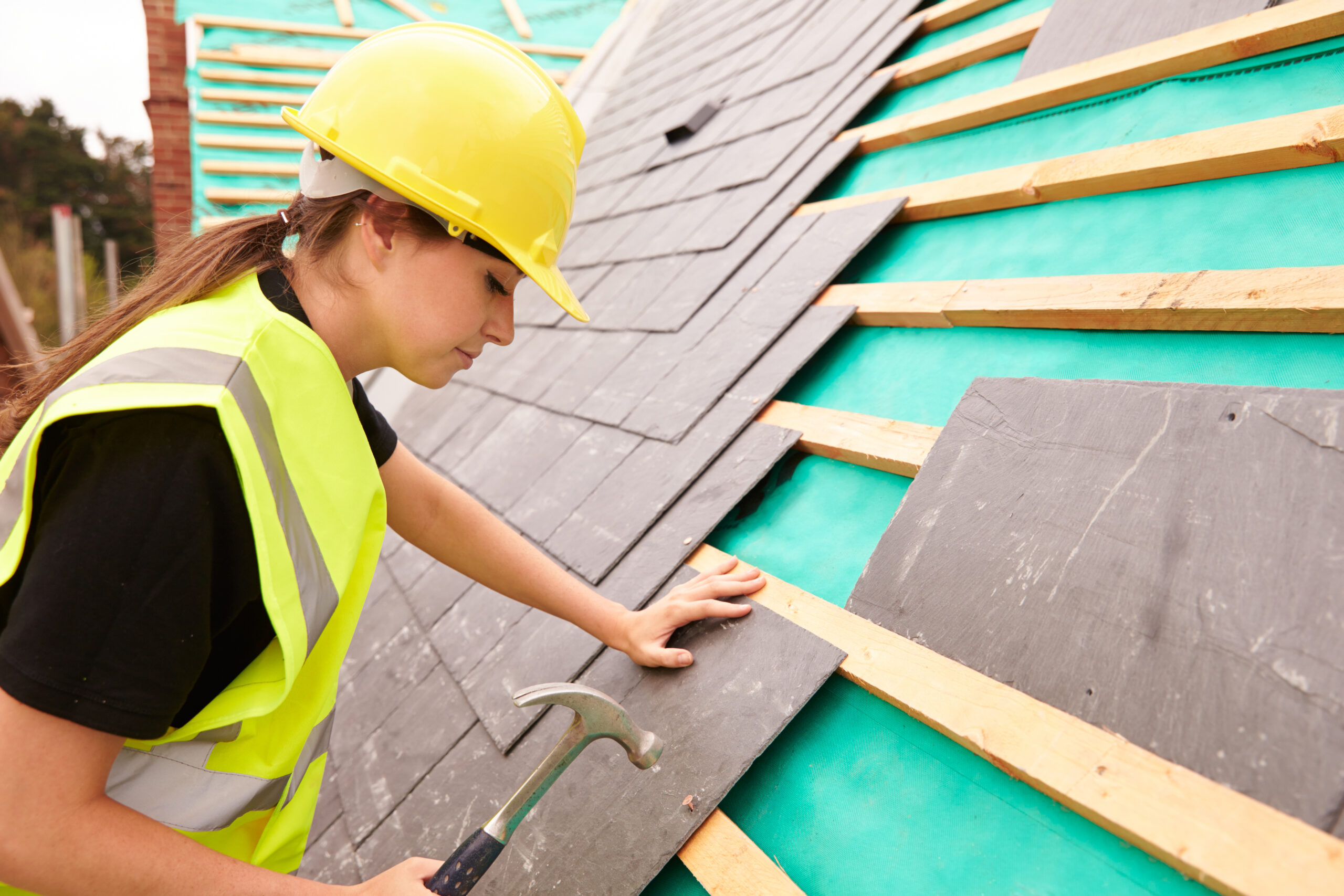 Female,Construction,Worker,On,Site,Laying,Slate,Tiles